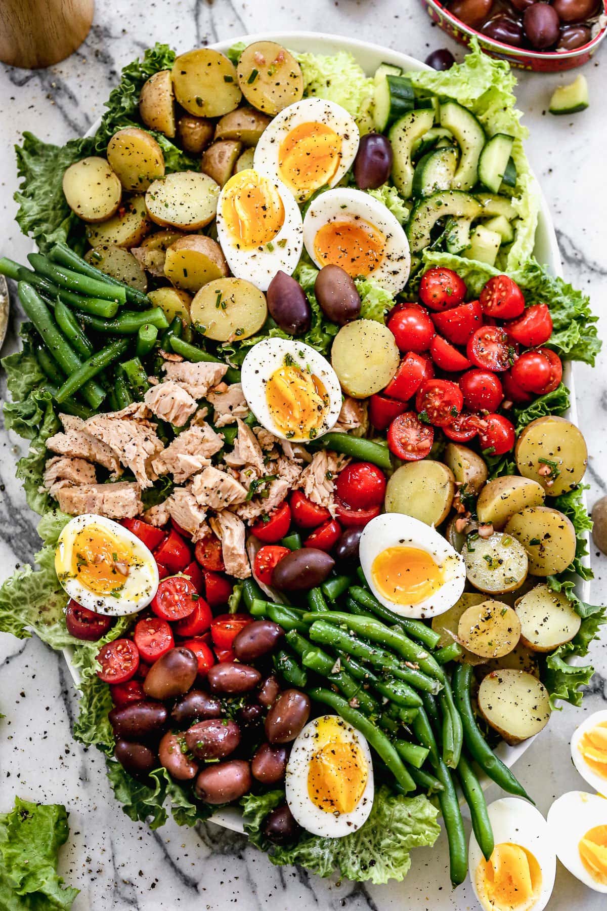 A big bowl of nicoise salad with capers