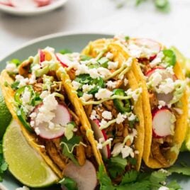 The BEST EVER Instant Pot Shredded Chicken Tacos! Easy, juicy pressure cooker Mexican chicken that's healthy and full of flavor. Use it for tacos, burritos, taco bowls, or mix with black beans and rice. #pressurecooker #instantpot #shreddedchicken #healthy