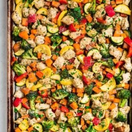 A sheet pan with chicken and rainbow vegetables