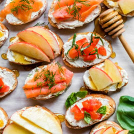 Easy whipped feta crostini with tomato, salmon, and apple toppings