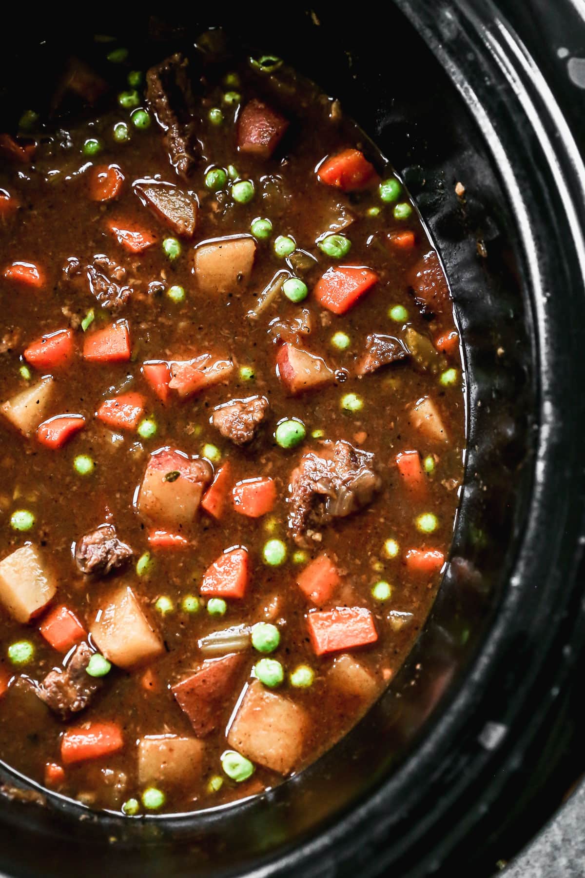 crock pot full of healthy beef stew with potatoes and carrots