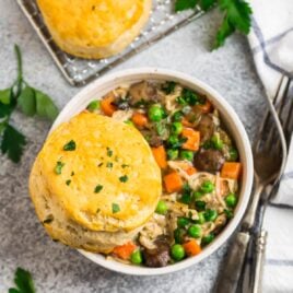 A bowl of crock pot chicken pot pie with biscuits