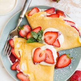 French strawberry crepes with cream filling on a plate
