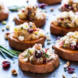 Baked Sweet Potato Rounds with Goat Cheese, Cranberry, Apple, and Pecans. An easy and addictive sweet potato appetizer! Healthy baked sweet potato slices roasted until crispy, then topped with a delicious combination of holiday flavors. Perfect easy appetizer for Thanksgiving, Christmas, and any party!