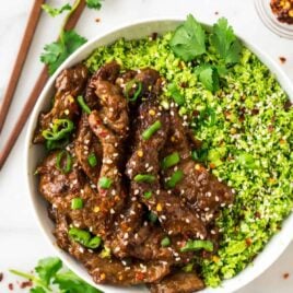 Healthy Beef and Broccoli! Easy, low carb recipe made with broccoli rice, and the most incredibly tender beef and delicious Mongolian sauce. Tastes like an authentic Chinese beef and broccoli recipe, but is made with clean eating ingredients. Perfect for busy families and meal prep dinners!