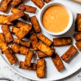 Air fryer tofu on a plate with dip