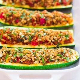 Healthy Italian Stuffed Zucchini Boats – low carb baked zucchini boats stuffed with lean ground turkey sausage, tomatoes, and topped with crispy basil breadcrumbs. An easy, healthy, all-in-one dinner that your whole family will love! Recipe at wellplated.com | @wellplated