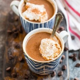 Two mugs of healthy hot chocolate made with almond milk and cacao
