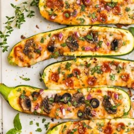 Zucchini pizza boats on a baking sheet